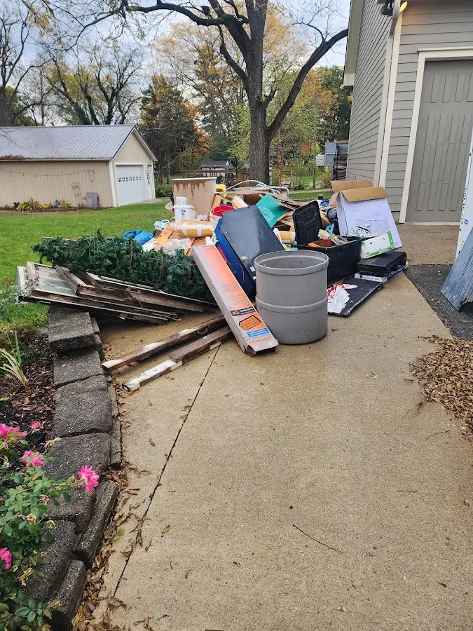 Dumpster being loaded with debris for Estate Cleanout Dumpster Rental in Woodfin